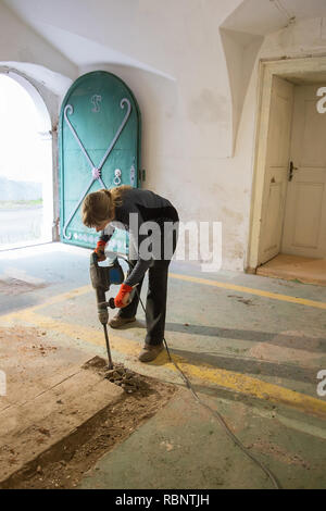 Woman working with jackhammer Stock Photo