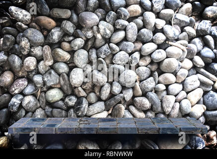 Empty blank stone display shelf on stone pebble background Stock Photo