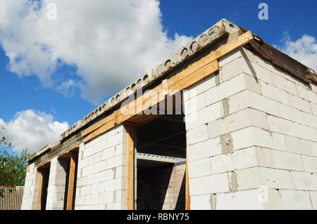 Building house construction.  Windows concrete lintel with iron bar on brick unfinished house construction. Close up on building house. Stock Photo