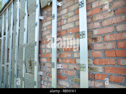 Brick house wall repair and rock wool or  mineral wool  wall insulation. External wall insulation - Save energy. Stock Photo
