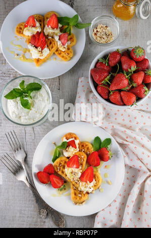 Delicate, melting  mouth-watering  Belgian waffles with whipped cream, strawberries, flavored with peanuts and honey.