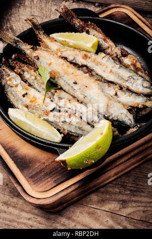 Fish fried breaded on iron cast pan.Deep-fried fish Stock Photo