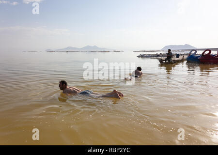 People are swimming in the salt Urmia Lake, West Azerbaijan province, Iran Stock Photo