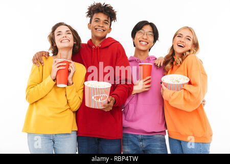 Group of cheerful multiracial friends watching a movie, eating popcorn, drinking soda isolated over white Stock Photo