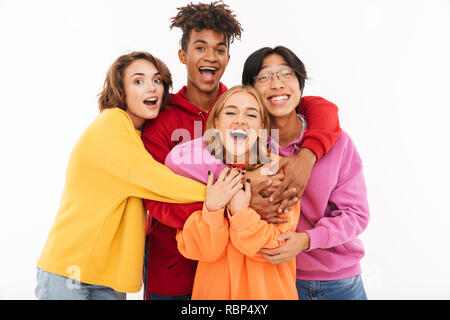 Group of cheerful teenagers isolated over white background, hugging Stock Photo