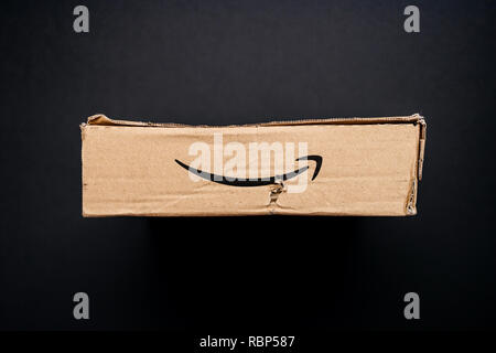 PARIS, FRANCE - APR 9, 2017: Directly above view of cardboard box from Amazon Prime with distinct online retailer logotype insignia and damaged pard Stock Photo