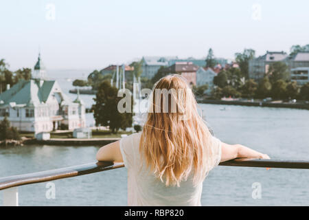 Woman sightseeing Helsinki city landmarks summer vacations in Finland traveling by ferry lifestyle blonde girl tourist relaxing alone Stock Photo