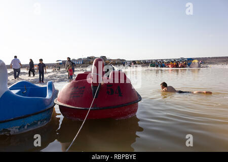 People are swimming in the salt Urmia Lake, West Azerbaijan province, Iran Stock Photo