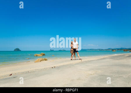 Young caucasian couple on sunny Teluk Yu beach on tropical Langkawi island in Malaysia. Beautiful nature of south east asia. Stock Photo