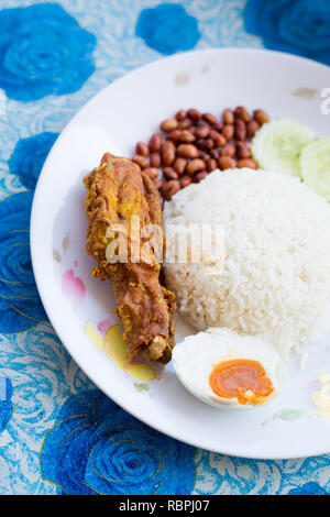 Fresh prepared malaysia nasi lemak set dish served with salted egg in local restaurant on Langkawi island. Traditional asian cuisine made of fresh ing Stock Photo