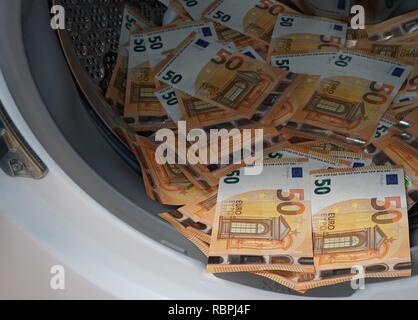 Money in washing machine Stock Photo