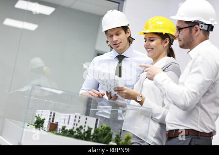 Group of architects sharing ideas in modern office Stock Photo