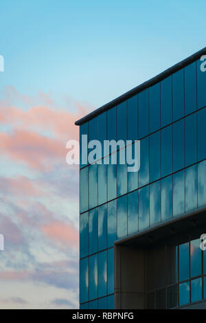 Modern building with curtain wall glass facade with cloudy sky reflections and background, black and white Stock Photo