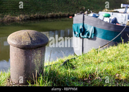 A barge is tied to a mooring post on a Ghent, Belgium canal Stock Photo