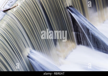 Fast flowing water over a concrete dam, California; long exposure Stock Photo