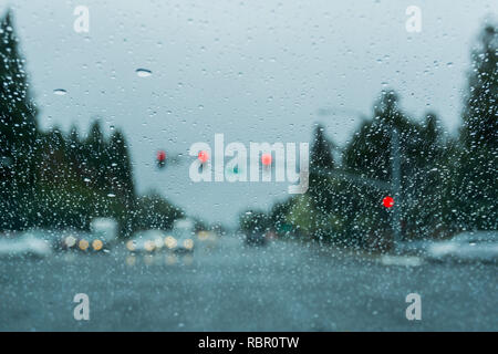 Raindrops on the windshield while driving on a rainy day; California Stock Photo