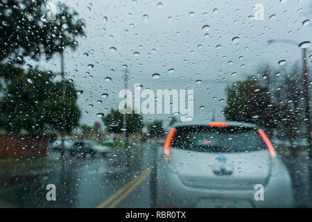 Raindrops on the windshield while driving on a rainy day; California Stock Photo