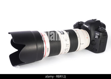 Canon 5D MARK IV DSLR camera with 70-200mm F2.8L IS II lens isolated on white background. Stock Photo