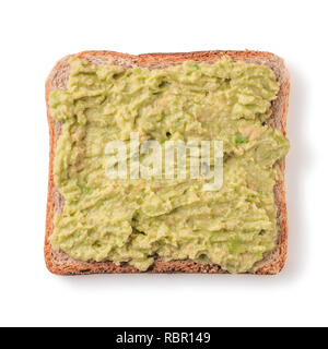 Bread slice with mashed avocado isolated on white, clipping path. Slice of multigrain bread square form plaster mashed avocado for toast. Top view or flat lay. Stock Photo