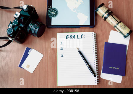 notepad, credit cards, passport, ticket, camera, phone and compass on a wooden background Stock Photo
