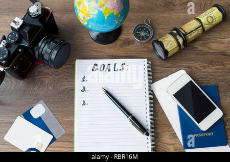 notepad, credit cards, passport, ticket, camera, phone and compass on a wooden background Stock Photo