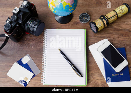 notepad, credit cards, passport, ticket, camera, phone and compass on a wooden background Stock Photo