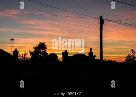 Sun setting behind the neighbourhood in Burgess Hill, West Sussex Stock Photo
