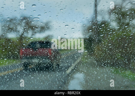 Raindrops on the windshield while driving on a rainy day, California Stock Photo