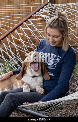 Renton Washington Usa Woman Being Affectionate With Her Five Month Old Basset Hound Puppy Elvis As They Rest In A Hammock Stock Photo Alamy