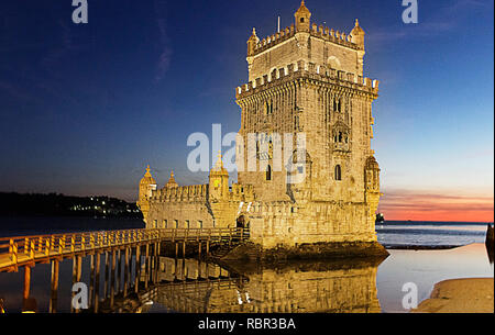 Historic Belem Tower in Lisbon at Twilight Reflecting on Calm Water Stock Photo