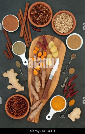 Spices for weight loss and slimming with fresh and dried turmeric, cumin, ginger, chilli, cinnamon and gymnema sylvestre used to suppress appetite. Stock Photo