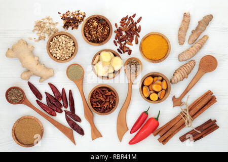 Spices for weight loss with turmeric, cumin, ginger, chilli, cinnamon and gymnema sylvestre used to suppress appetite. Top view on rustic wood backgro Stock Photo