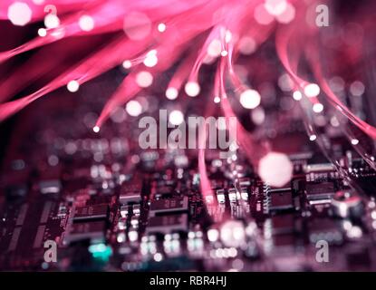 Fibre optics carrying data over electronic circuitry on a laptop computer. Stock Photo