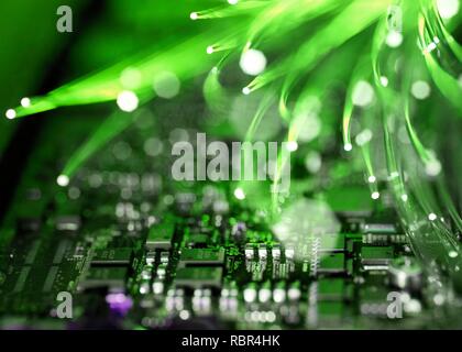 Fibre optics carrying data over electronic circuitry on a laptop computer. Stock Photo