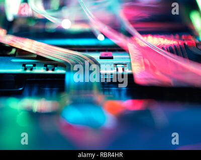 Fibre optics carrying data over electronic circuitry on a laptop computer. Stock Photo