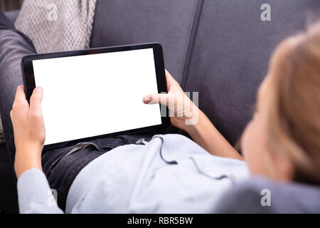 Close-up Of A Girl's Hand Using Digital Tablet With Blank White Screen Stock Photo