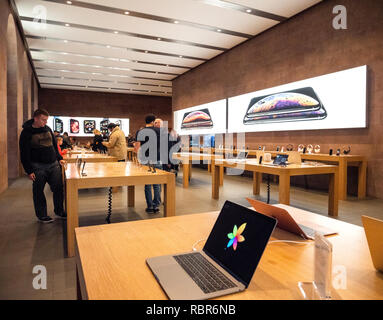 PARIS, FRANCE - OCT 25, 2018: Apple Computers Store with customers inside admiring iPhone Xs XR smartphones - shopping for latest electronics Stock Photo