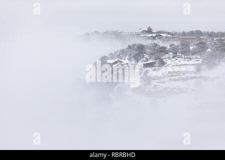 Kolb Studio and the El Tovar Hotel at the rim of the Grand Canyon filled with clouds and fog in Grand Canyon National Park, Arizona Stock Photo