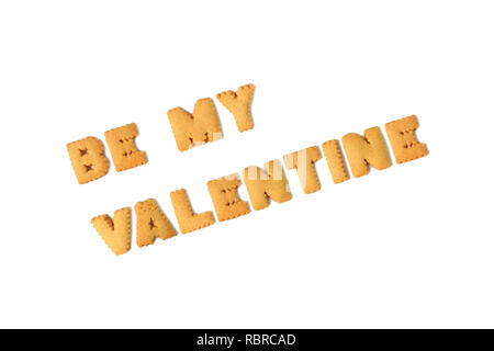 Top view of the word BE MY VALENTINE spelled with alphabet shaped biscuits isolated on white background Stock Photo