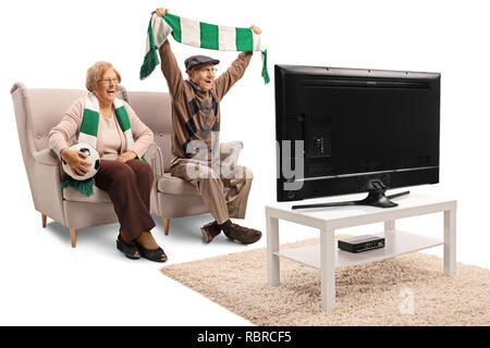 Senior female and male soccer fans cheering with a scarf and watching a game isolated on white background Stock Photo