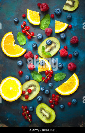 Fresh summer berries and fruits on dark  background. Healthy food concept. Flat lay. Fruit background. Stock Photo