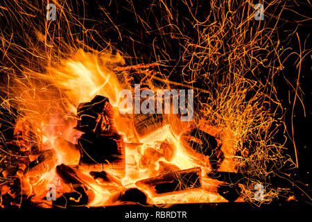 Burning firewood in the fireplace close up, BBQ fire, charcoal background. Charcoal fire with sparks Stock Photo