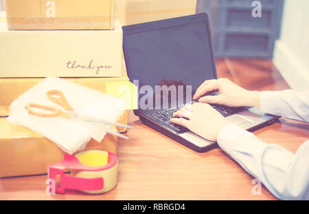 shipping laptop selling things online ecommerce delivery shopping online and order concept / cardboard box parcels on table packing shipping for custo Stock Photo