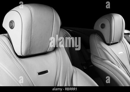 Modern Luxury car inside. Interior of prestige modern car. Comfortable leather seats. Perforarated leather with isolated Black background. Modern car  Stock Photo