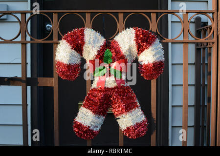 Candy Cane Christmas Decoration on Front Gate of Townhouse Stock Photo