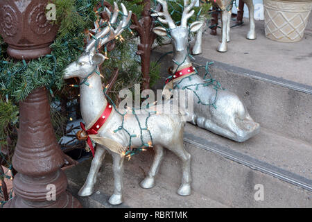 Christmas Reindeer and Garland Decorations On Townhouse Steps Stock Photo