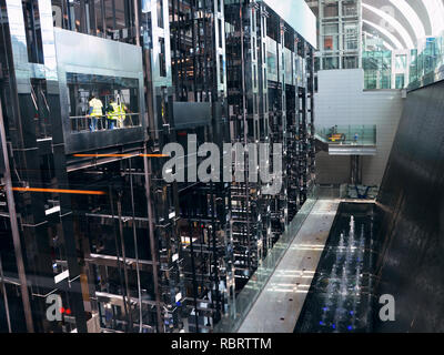 Dubai Airport, UAE - October 8th, 2017: Modern architecture with large lifts and water fountains inside of Dubai airport Stock Photo