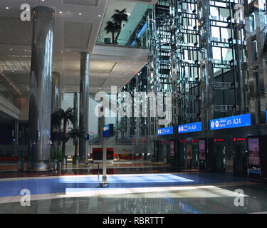 Dubai Airport, UAE - October 8th, 2017: Modern architecture with large lifts and water fountains inside empty Dubai airport Stock Photo