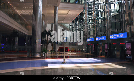 Dubai Airport, UAE - October 8th, 2017: Modern architecture with large lifts and water fountains inside empty Dubai airport Stock Photo