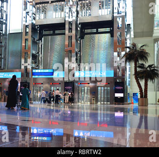 Dubai Airport, UAE - October 8th, 2017: Modern architecture with large lifts and water fountains inside of Dubai airport Stock Photo